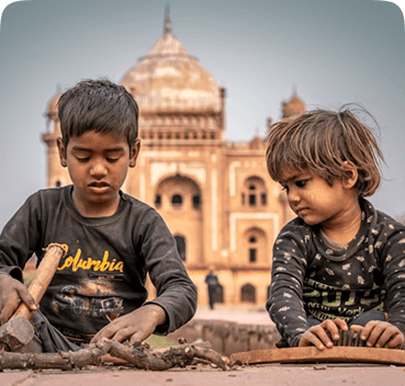 Two boys playing near a historic monument during a Pararthya field trip